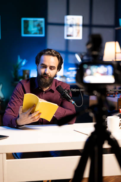 istock Experienced voice actor in studio working on audiobook recording production 2043186462