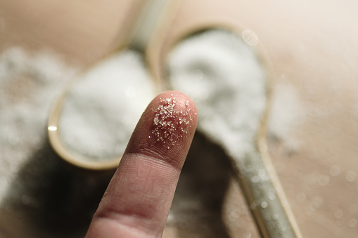 Close-up of a finger with sugar grains