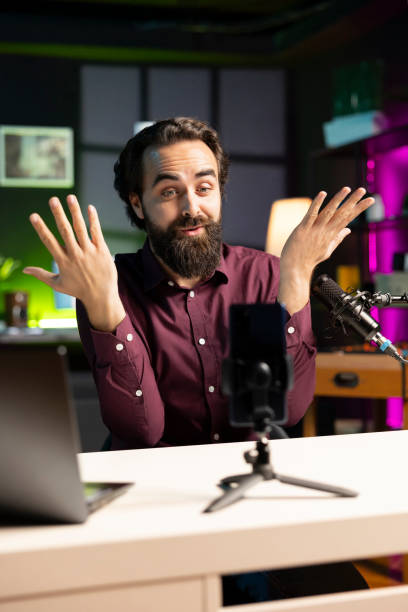 istock Influencer making energetic hand movements, filming with smartphone 2043197479