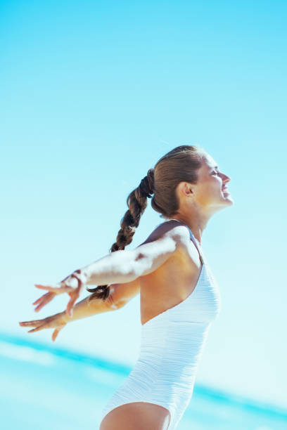 istock happy young woman rejoicing at seaside 2043199052