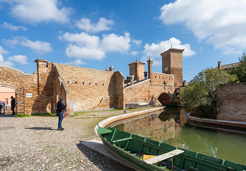 Comacchio, Italy. February 25, 2024.  view of the tourists visiting the Trepponti Bridge in the center of the town