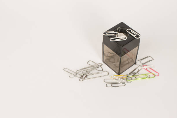 A Magnetic paper clip holder with clips all around it.