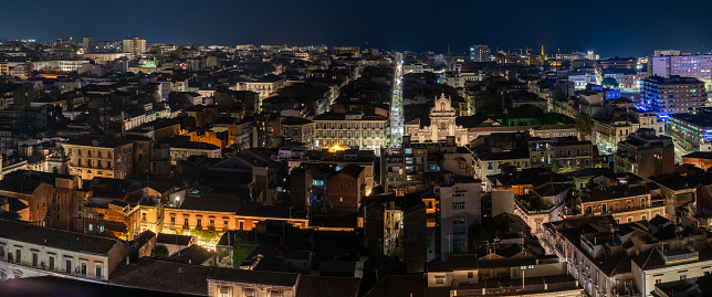 Night aerial view from the center to the sea of the city of Catania, Sicily, Italy