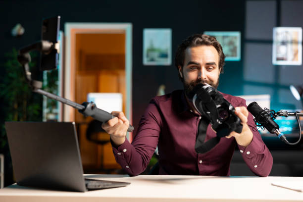 istock Tech vlogger reviewing VR glasses in apartment studio, presenting specifications 2043212962