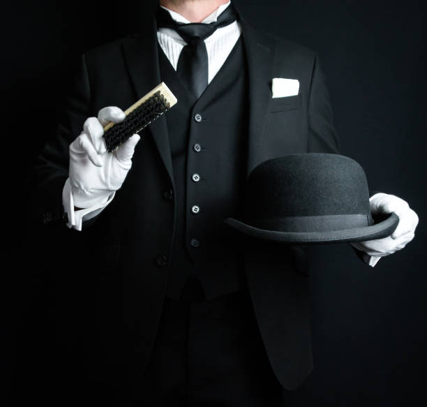 istock Butler Brushing Bowler Hat 2043219260