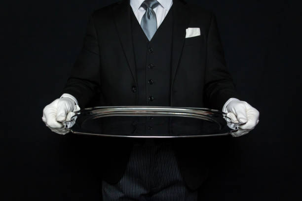 butler holding serving tray - silver platter concierge waiter butler photos et images de collection