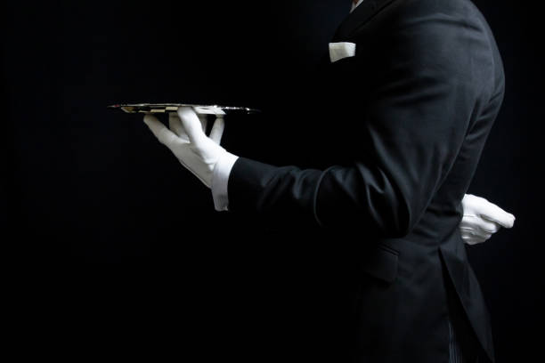 hand in white glove holding empty serving tray