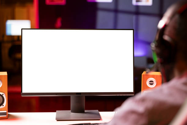 istock Mockup display used by man playing on PC, using headphones to talk, close up 2043228340