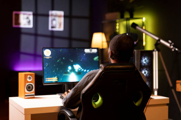 istock Gamer enjoying spaceship flying game on computer desktop 2043231120