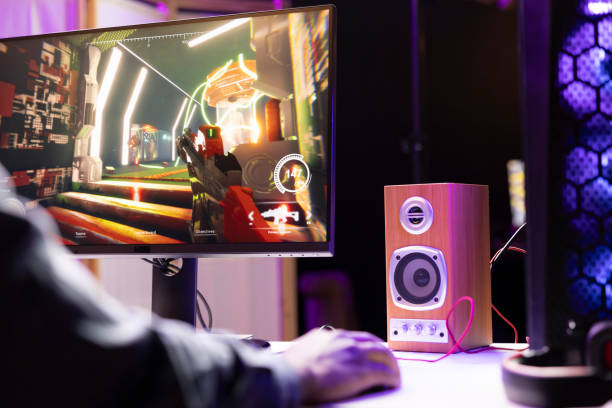 istock Man in apartment at night using stereo speaker, playing games 2043232629