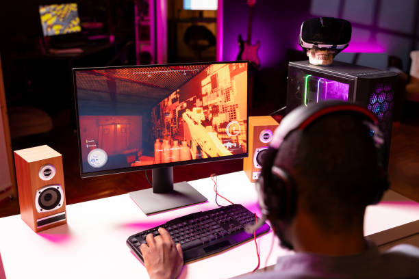 istock Man playing science fiction FPS videogame, having fun in dark apartment room 2043240618