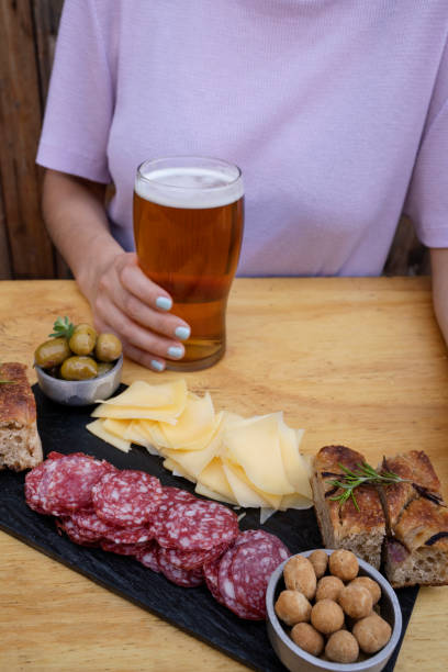 istock A woman having a beer and a traditional Argentinian picada 2043241164