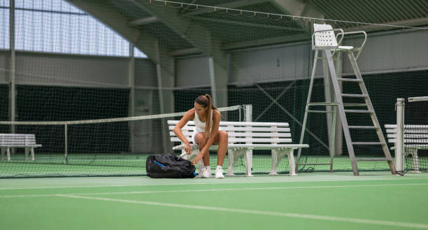 istock Female Tennis Player Sitting On Bench 2043250228
