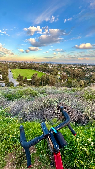 View from behind the bike handlebars looking at the Will Rogers State Historic Park Polo Field. Picture taken in Los Angeles during sunset.