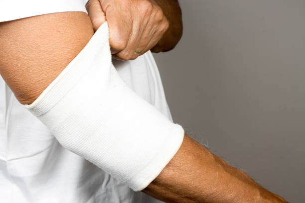 istock Man wearing an ace bandage on his elbow 2043277153