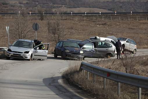 Ihtiman, Bulgaria - February 15, 2024: Fire and rescue units work at a car crash on the A1 highway junction near the town of Ihtiman, Bulgaria.