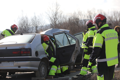 Ihtiman, Bulgaria - February 15, 2024: Fire and rescue units work at a car crash on the A1 highway junction near the town of Ihtiman, Bulgaria.