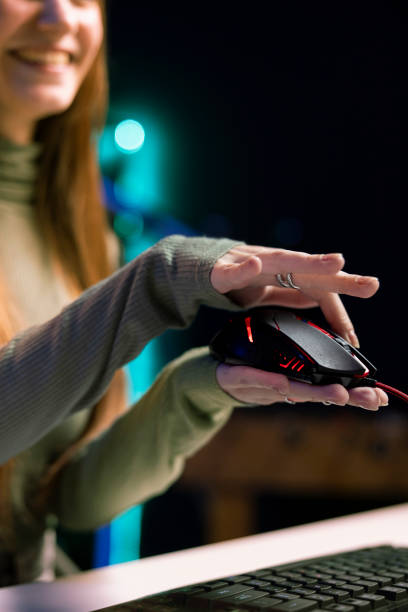 Joyous gen Z entertainer presenting wired gaming mouse from brand, close up