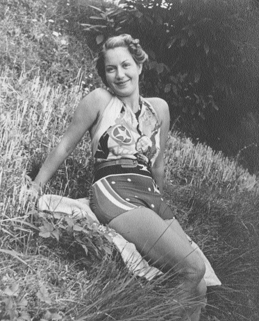 Young woman sitting on a field. 1933.