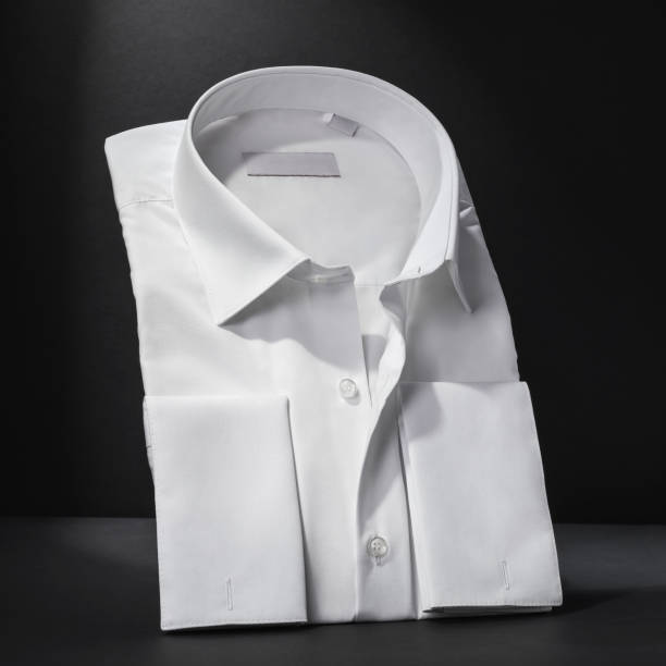 istock White classic folded long sleeve men's shirt on a dark background, close-up 2043307209