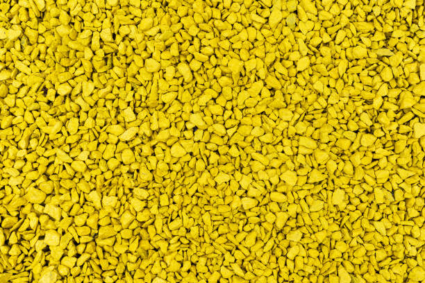 istock Flat background of small stones painted yellow 2043308753