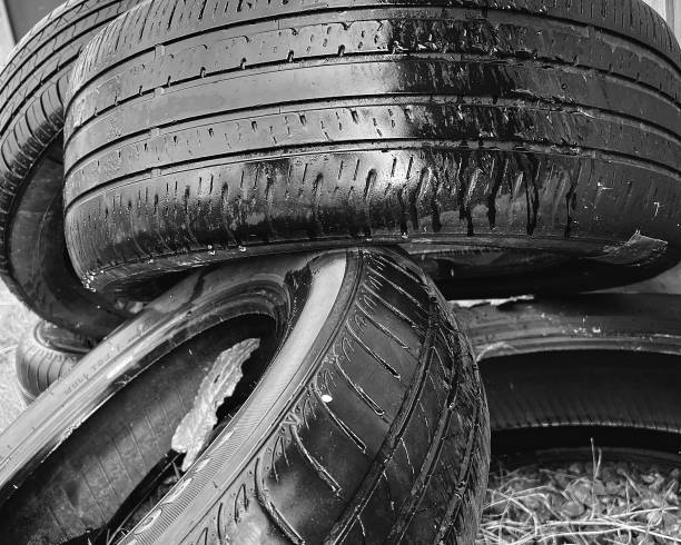 black and white photo of old car tires.