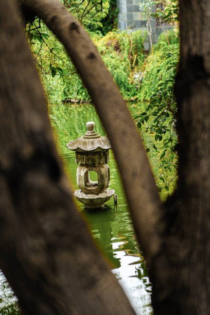 istock Reflections in the water, trees, and Chinese style architecture 2043330621