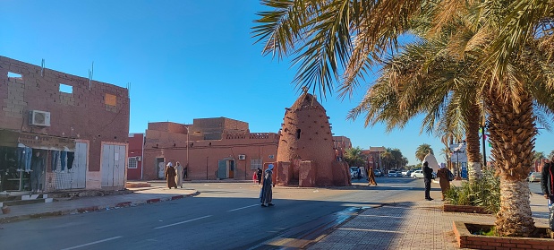 Street view of the beautiful architecture made of red clay in the city of Timimoun, Algeria