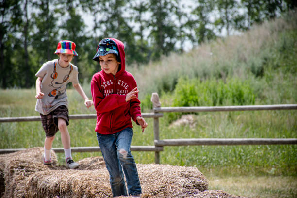 Blur and soft focus Happy Children wearing a white shirt is playing on straw.