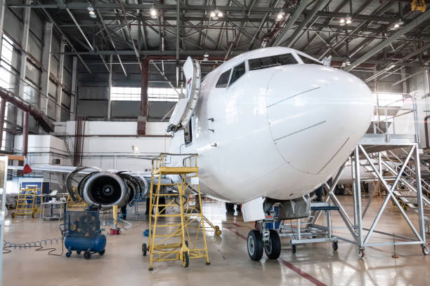 istock White passenger airplane in the aviation hangar. Airliner under maintenance 2043401340