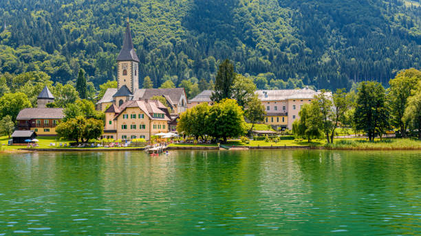 View to Ossiach from lake Ossiacher View to Ossiach from lake Ossiacher villach stock pictures, royalty-free photos & images