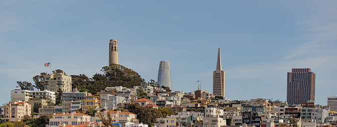 Telegraph Hill San Francisco, CA USA with American Flag, Coit Tower, Salesforce Tower, Transamerica Pyramid and 555 California St. shown along with the unique homes of the city. Wide Shot