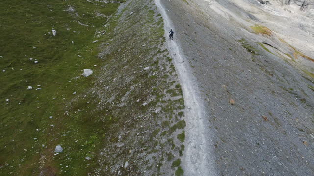 Aerial view of mountain biker descending moraine ridge