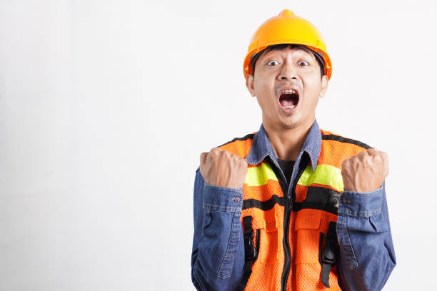 Asian engineer handsome man or architect looking forward with white safety helmet. prepare modern building construction. Worker asian man happy face