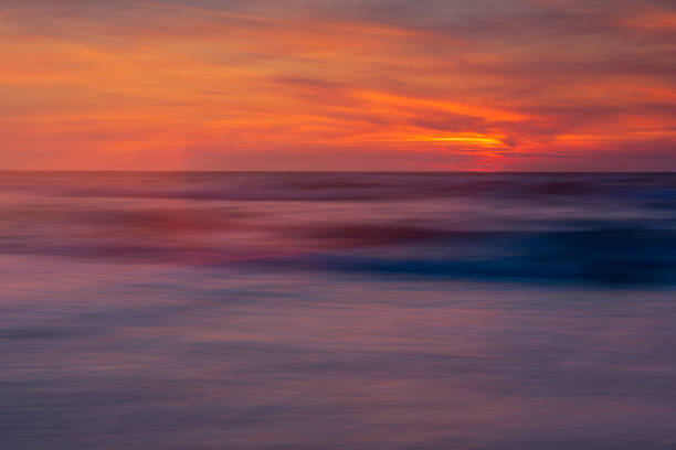 istock blurred sea, illuminated with the colors of the setting sun 2043448686