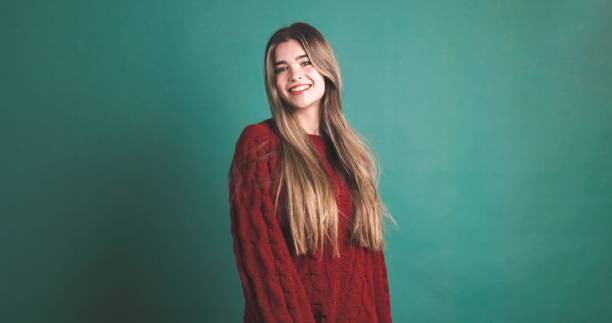 istock Happy woman with long blonde hair smiling in green studio 2043448708