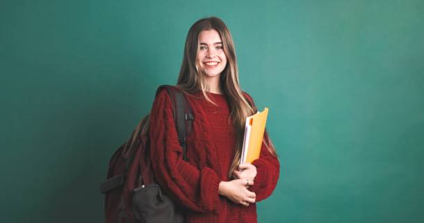 istock Happy female university student carrying backpack and holding books 2043448865