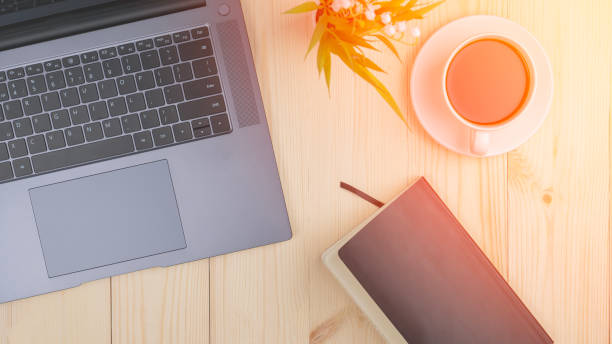 istock Coffee Crook Laptop And Black Notebook On Wooden Table Top View, Tinted Image, Selective Focus 2043470300