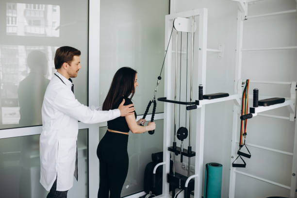 istock Young woman making spine examination in diagnostics machine with physiotherapist. 2043483084