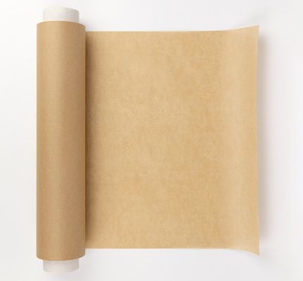 An unrolled roll of parchment paper. Parchment paper for baking. The concept of burning during baking