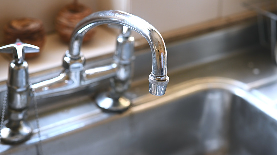 Kitchen, silver and closeup of a tap and basin for plumbing, home equipment and cleaning. Silver, design and a faucet in a house for water supply, clean homeware and a stainless steel handle