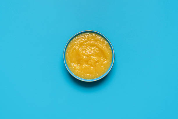 istock Apple sauce bowl above view, isolated on a blue background 2043510402