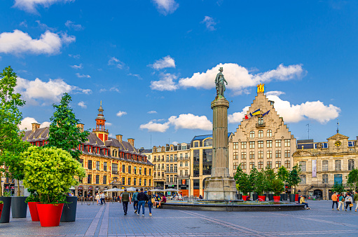 Lille, France, July 3, 2023: La Grand Place square General de Gaulle in old town, Vieille Bourse, Column of the Goddess and La Voix du Nord, Theatre du Nord building, French Flanders, Nord department