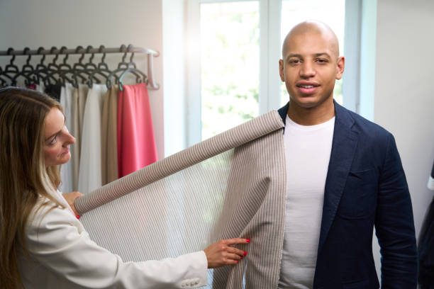 istock Experienced fashion designer choosing textile for customer clothing 2043537726