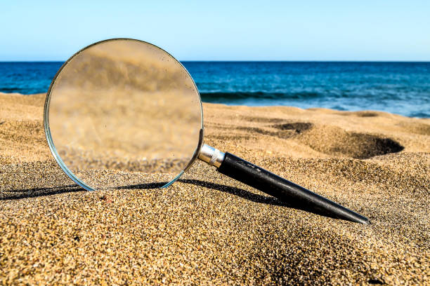 istock Magnify Glass on the Sand Beach 2043551258