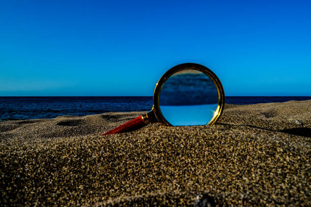 istock Magnify Glass on the Sand Beach 2043551832