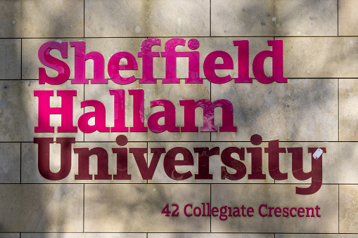 Sheffield, South Yorkshire, United Kingdom - November 24, 2024: A Sign for Sheffield Hallam University campus on Collegiate Crescent in Sheffield.