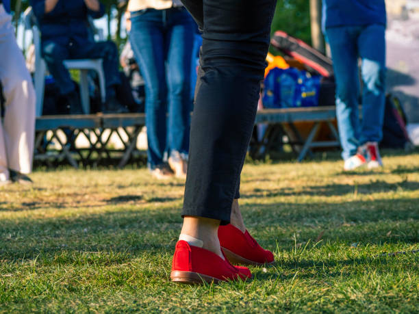 People dancing typical Catalan sardanas in a park during a traditional national holiday.