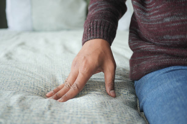 istock Hand touching and pressing orthopedic mattress on bed. 2043610577