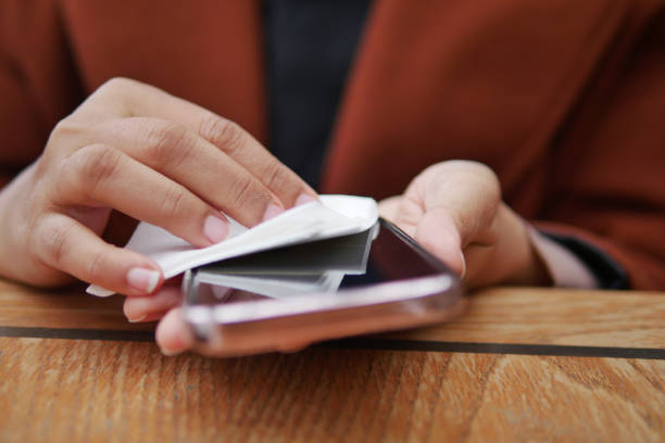 istock women cleaning mobile phone display for preventing virus 2043613220
